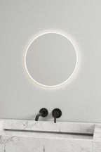 Round mirror featuring soft, warm lights for a cozy atmosphere