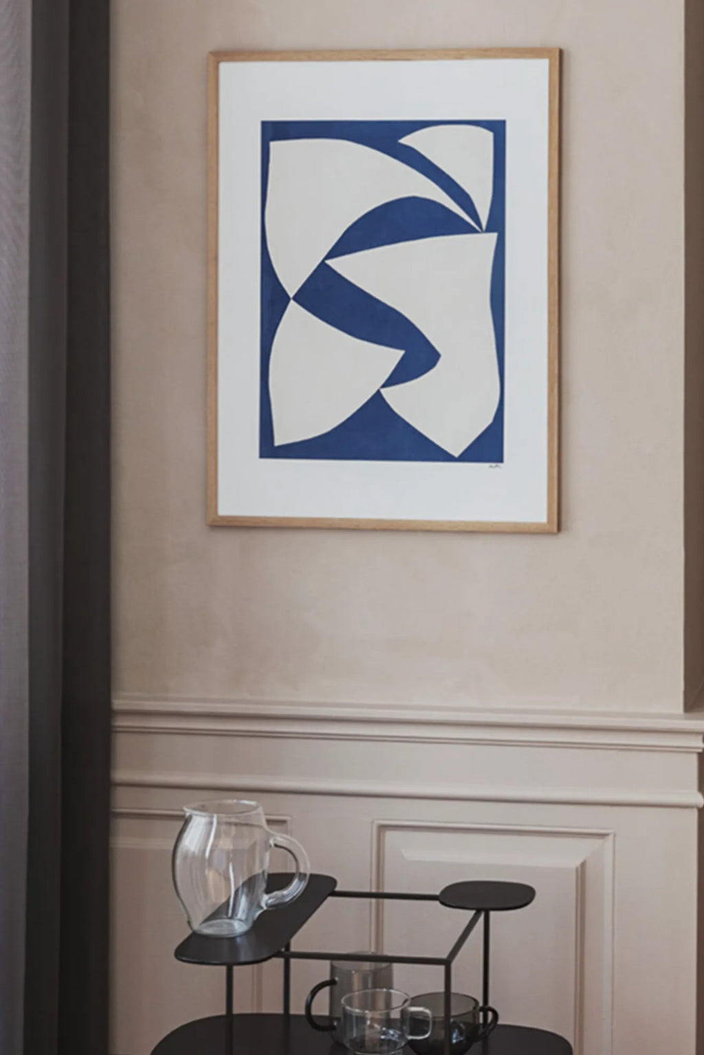The Poster Club Dynamics, an abstract art print featuring bold off-white organic shapes against a vibrant royal blue background, framed in a light natural oak frame with a crisp white mat. This modern minimalist poster is perfect as contemporary wall art for gallery walls or Scandinavian living rooms.