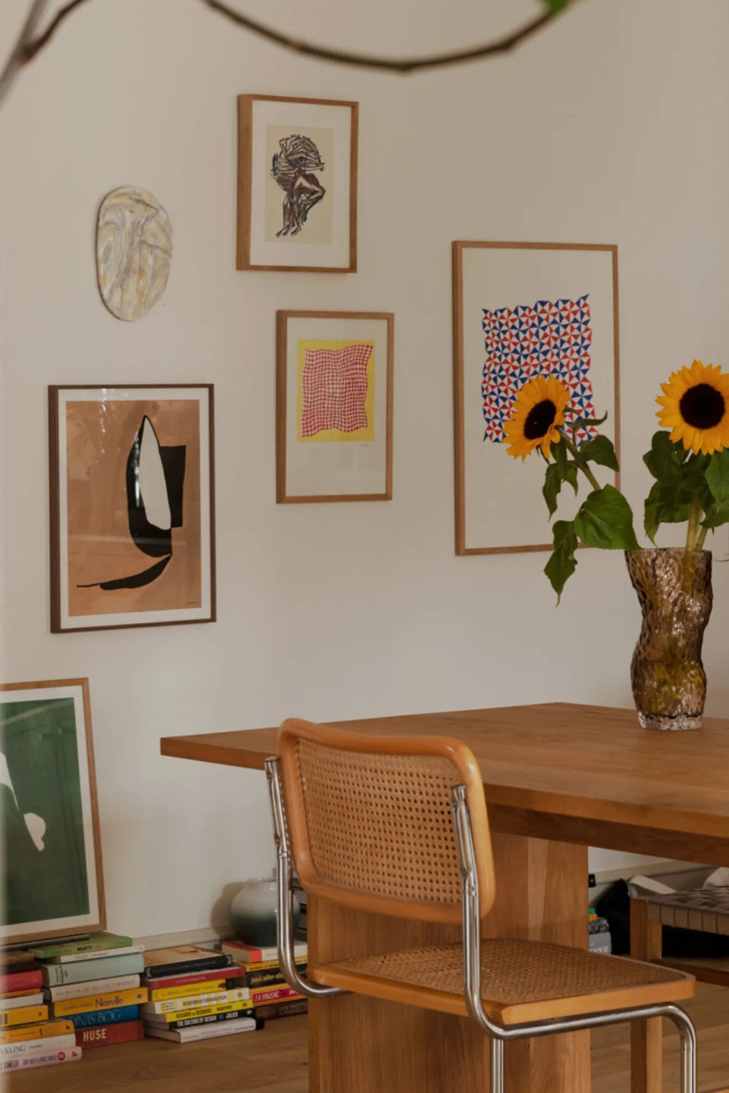 The Poster Club Tern No. 3, a minimalist abstract art print showcasing bold black and white organic shapes against a warm brown and beige background, housed in a light natural oak frame. This contemporary wall art piece is ideal for modern gallery walls, Scandinavian living rooms, or minimalist home office styling.