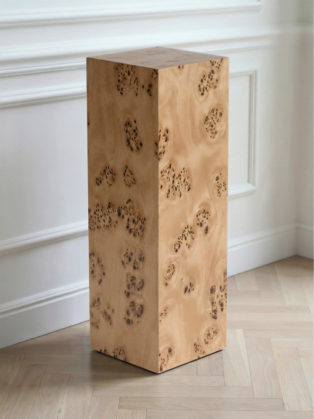 TCL Studios Monolith Burlwood Display Column, a modern minimalist side table crafted from natural burl wood, featuring a striking organic grain with rich honey tones and dark figured patterns. This tall rectangular column boasts a smooth, polished finish and a monolithic contemporary design. Perfect as a luxury display pedestal for art or a unique accent table for organic modern living rooms and sophisticated entryways.
