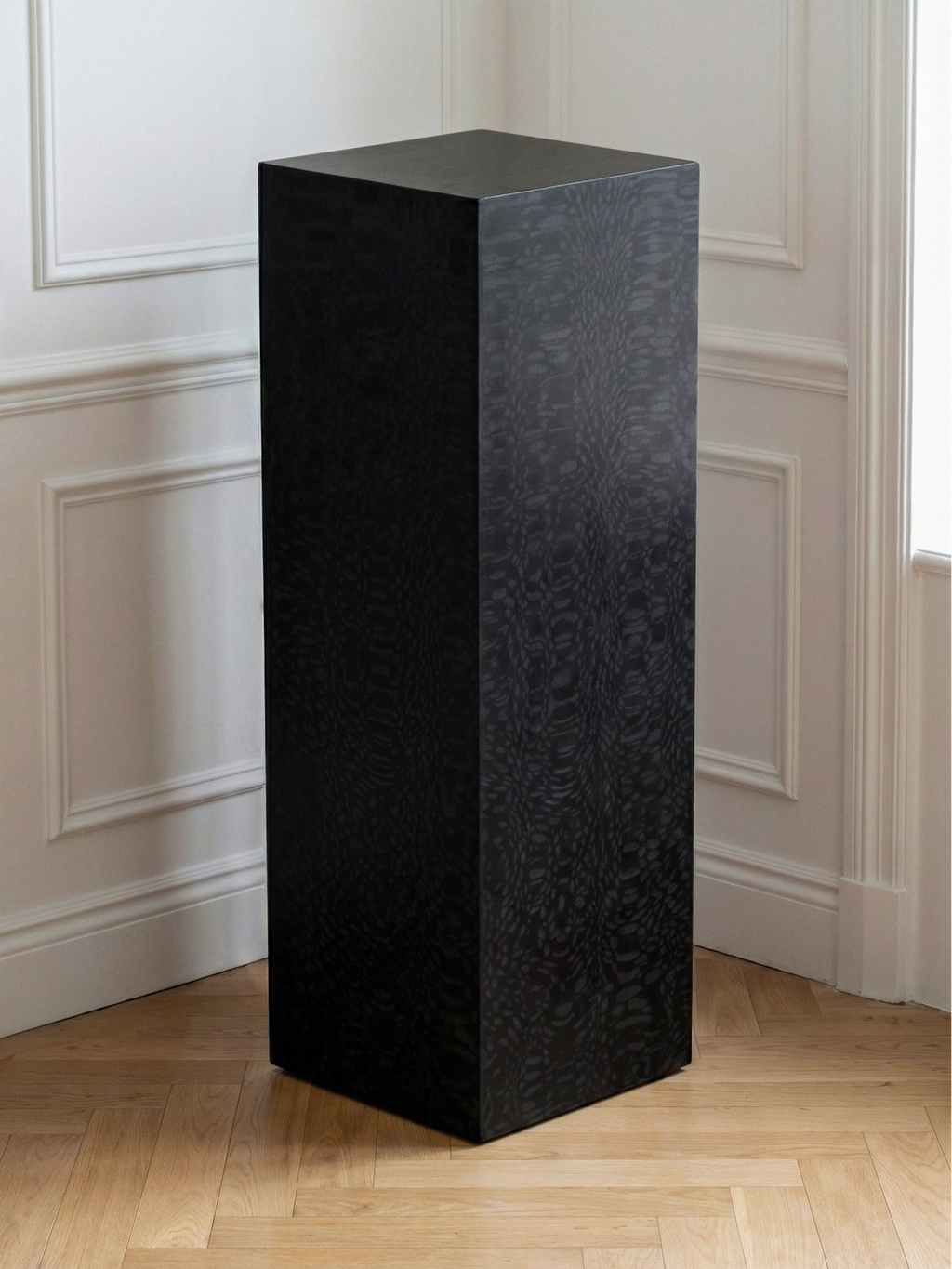TCL Studios Monolith Lacewood Display Column, a sleek modern minimalist pedestal crafted from dark lacewood with a distinctive, subtly textured black wood grain pattern and a bold rectangular prism silhouette. This contemporary architectural column serves as an elegant display stand or sculptural accent table for living rooms, entryways, or gallery-style interiors.