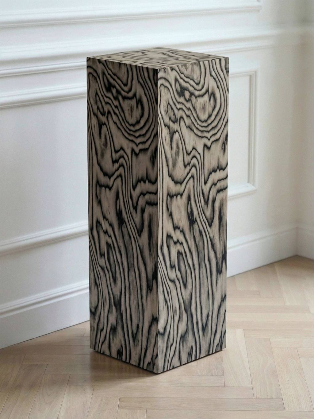 TCL Studios Monolith Sottsass Display Column, a striking modern minimalist wood plinth featuring a graphic black and white wood grain pattern across its rectangular silhouette.
