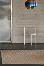 Hand-woven cream-colored Monte Rug made of high-quality wool and featuring a modern geometric pattern