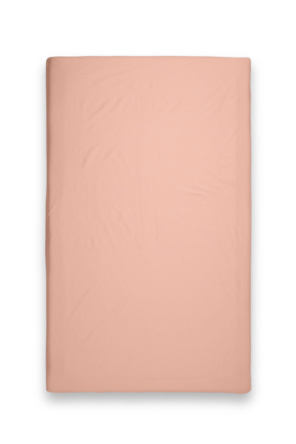 Magniberg Mother Poplin Fitted Sheet, a soft peach-colored luxury fitted sheet crafted from crisp cotton poplin fabric, featuring a smooth texture and subtle creases. This minimalist bedding is perfect for creating a serene and contemporary Scandinavian bedroom aesthetic.