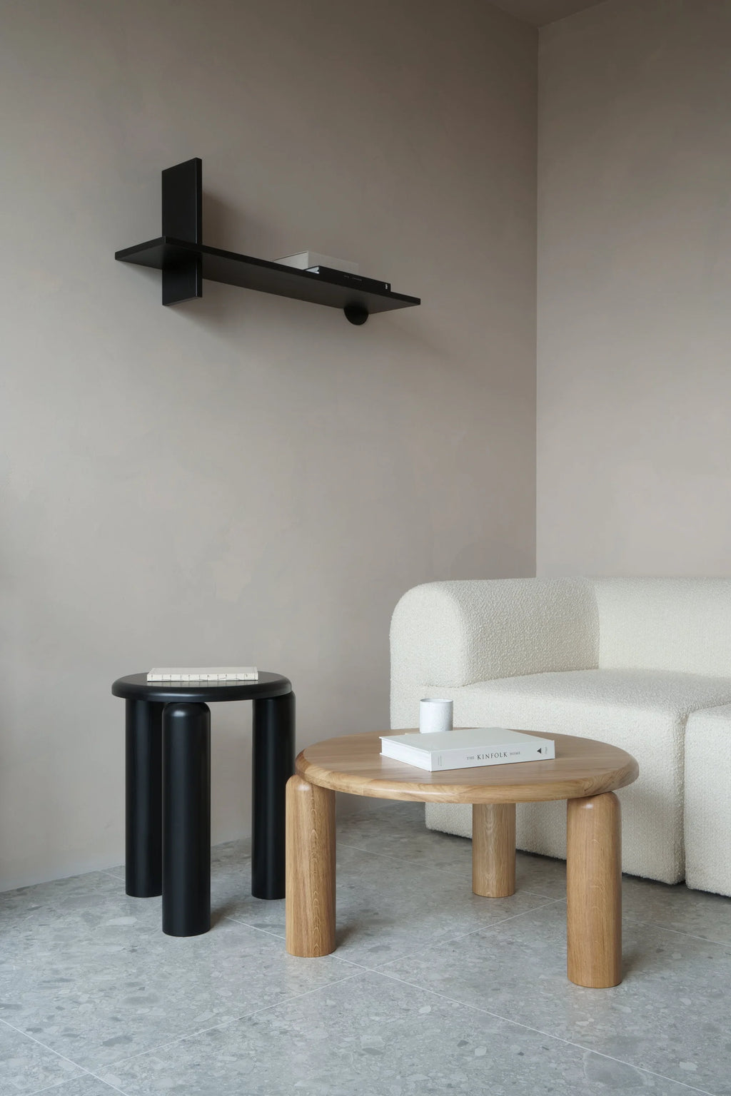 TAMO Neo Side Table in a lifestyle setting, showcasing a circular natural oak wood top and three sturdy cylindrical legs. This luxury furniture piece pairs beautifully with modern interiors.