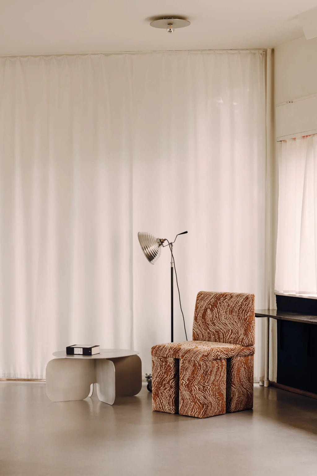 NG DESIGN Object 105 Coffee Table, a minimalist light grey/beige lacquer finish table with rounded edges and a unique base, styled in a luxurious living room. Perfect for modern spaces.