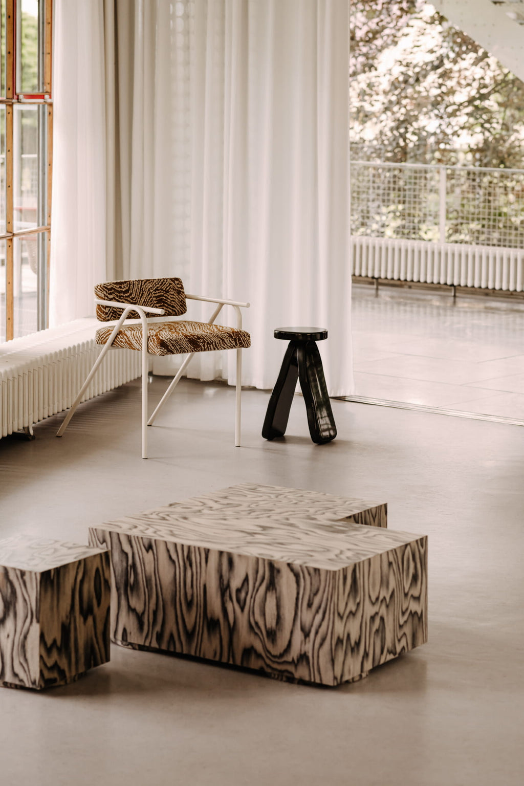 NG DESIGN Object 107 Side Table in a lifestyle setting, featuring its sleek black gloss finish and distinctive three-legged design. This luxury Scandinavian side table complements any modern interior.