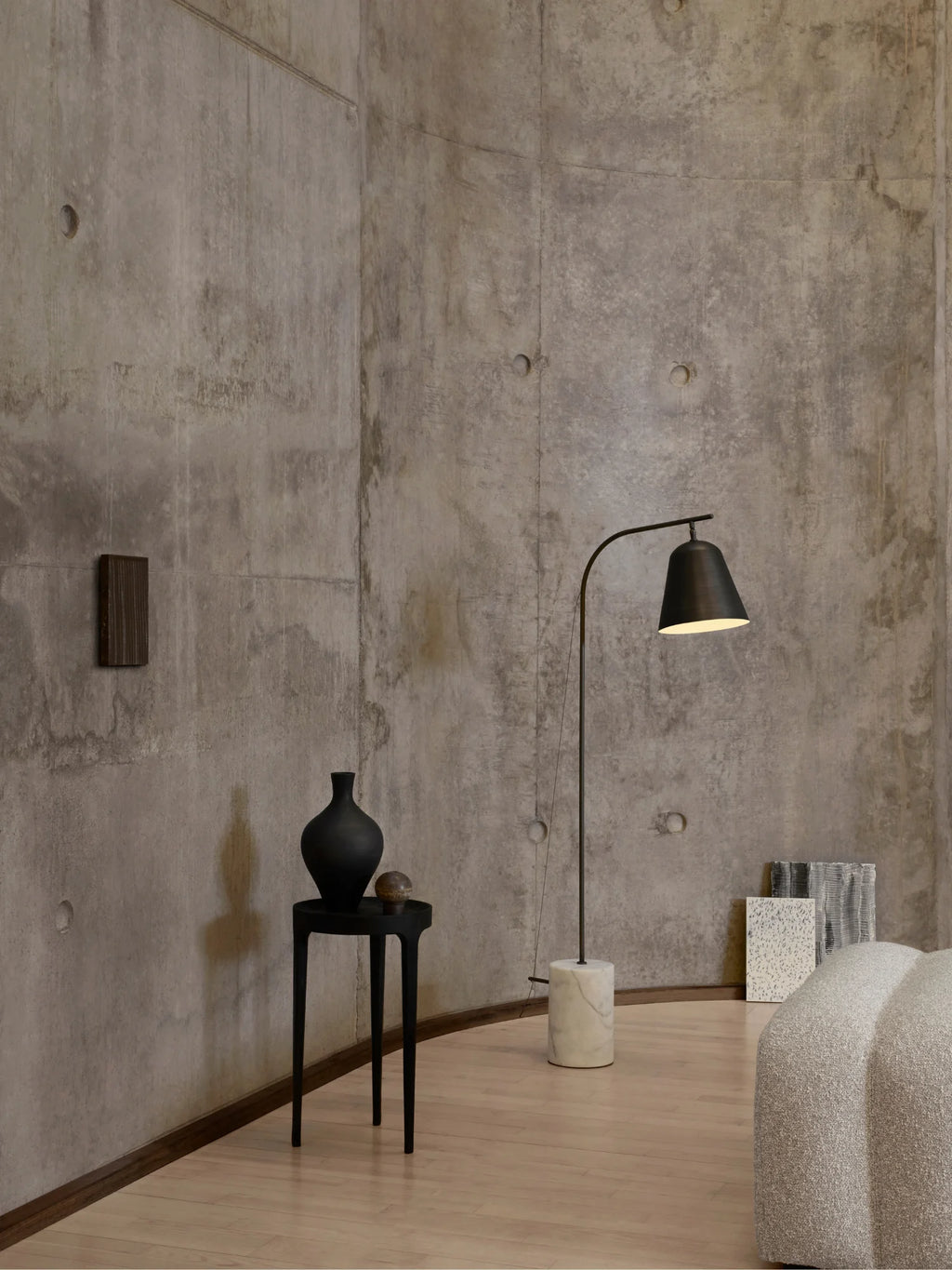 NORR11 Ghost Side Table, a sleek modern minimalist side table crafted from matte black wood, featuring a perfectly round tabletop and three slender, tapered legs. Its elegant, sculptural silhouette makes it an ideal accent table for contemporary living rooms, minimalist bedrooms, or Scandinavian-inspired spaces.