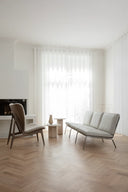 Modern living room with a gray sofa and chair on a wooden floor.