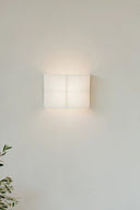 Alt text: The Nebra Wall Lamp, a modern and elegant lighting fixture with a sleek design and adjustable arm, perfect for adding ambiance to any room