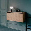 White wooden cabinet with two doors and silver handles, perfect for storing items