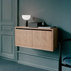 White wooden cabinet with two doors and silver handles, perfect for storing items