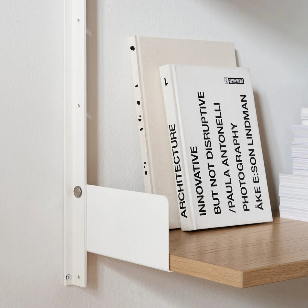 New Works Display Shelf, a modern minimalist wall-mounted shelving unit featuring a crisp white powder-coated steel upright and an L-shaped bracket supporting a smooth light natural oak wood shelf. This Scandinavian-inspired display shelf is perfect for contemporary living rooms, home office organization, or minimalist shelf styling.