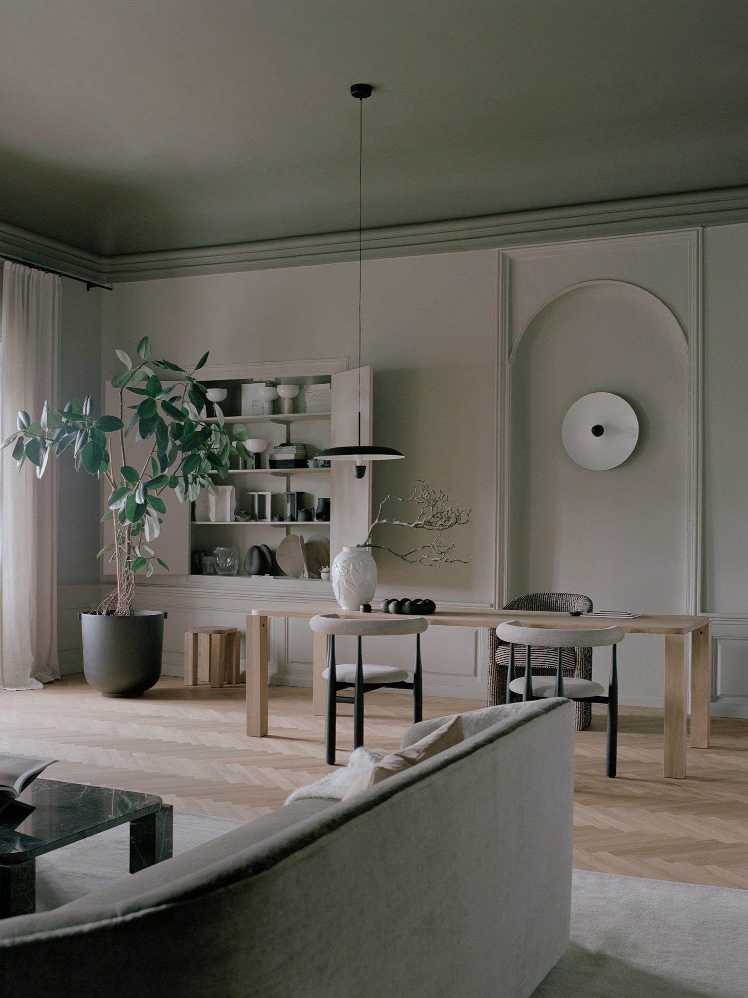 New Works Kantarell Wall & Ceiling Lamp, a striking modern minimalist wall light featuring a large, matte white circular metal disc with a contrasting matte black central accent. This sculptural Scandinavian design provides ambient lighting and doubles as contemporary wall art. Perfect for modern living rooms, entryways, or as unique bedroom lighting in Nordic-inspired interiors.