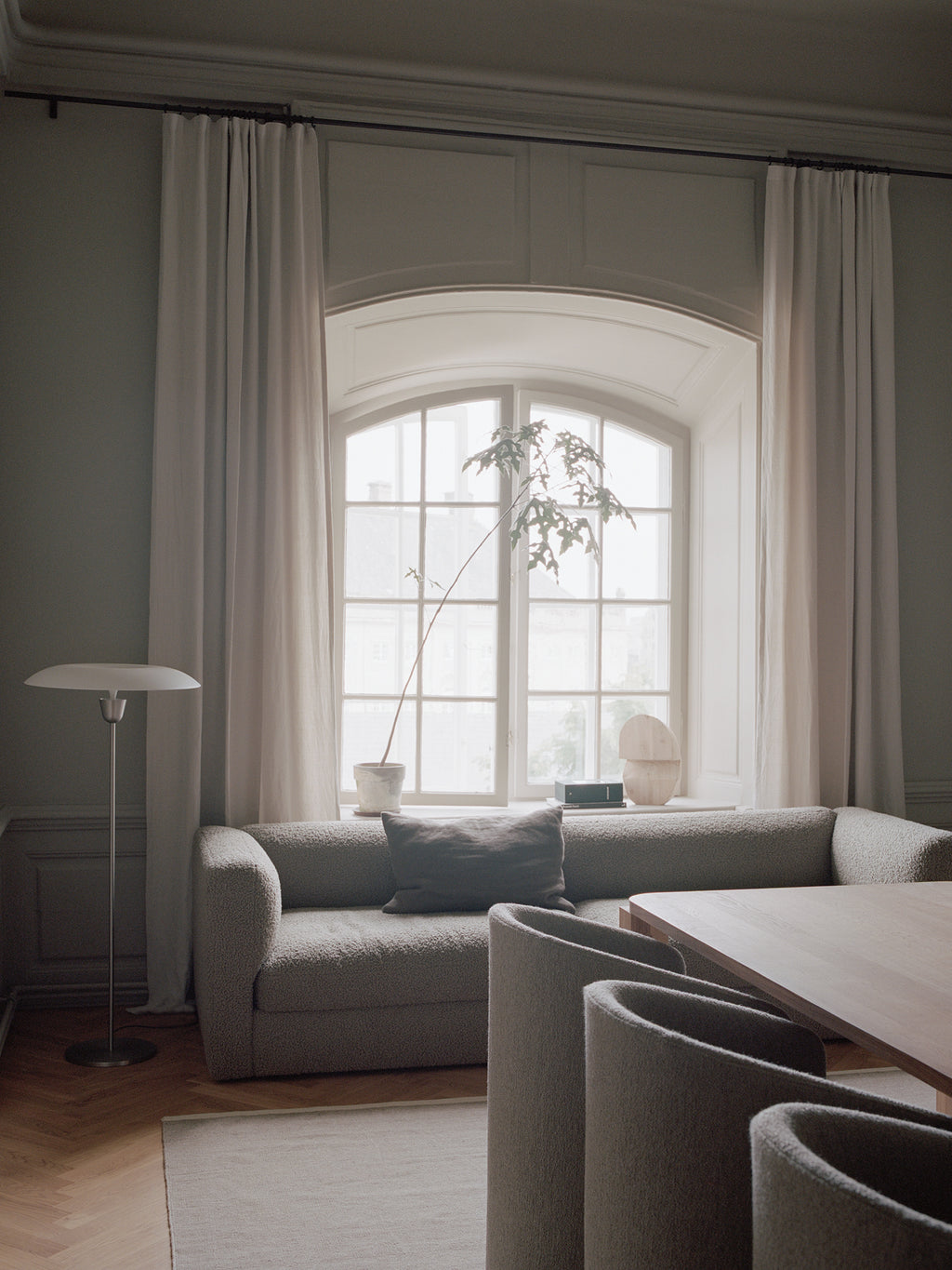 New Works Kantarell Floor Lamp, a sleek mid-century modern floor lamp featuring a distinctive mushroom-shaped opal glass shade that emits a soft, diffused glow. Its slender brushed steel stem and round base provide a minimalist and elegant profile, embodying Scandinavian design principles. Ideal as a contemporary accent lamp or reading lamp for living rooms, bedrooms, or cozy minimalist spaces.