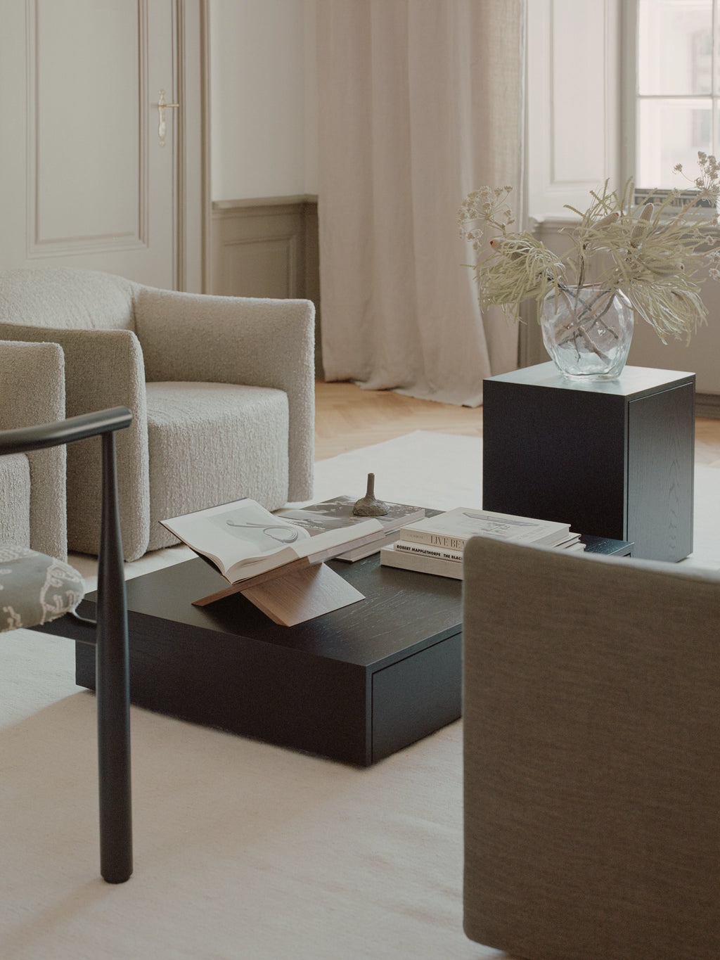 New Works Mass Side Table w. Drawer, a sleek modern minimalist side table with a clean-lined geometric cube silhouette, crafted from dark stained oak with a smooth matte black finish and featuring a discreet storage drawer. This contemporary end table is ideal for modern living room interiors or as a functional Scandinavian nightstand in bedrooms.
