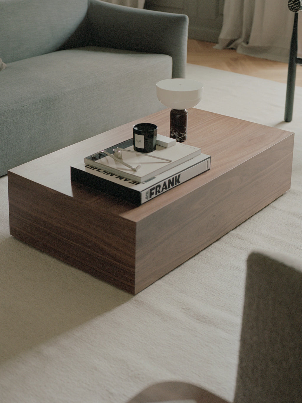 New Works Mass Coffee Table, a modern minimalist rectangular coffee table crafted from rich dark walnut wood with a smooth, clean-lined finish and a substantial block-like silhouette.