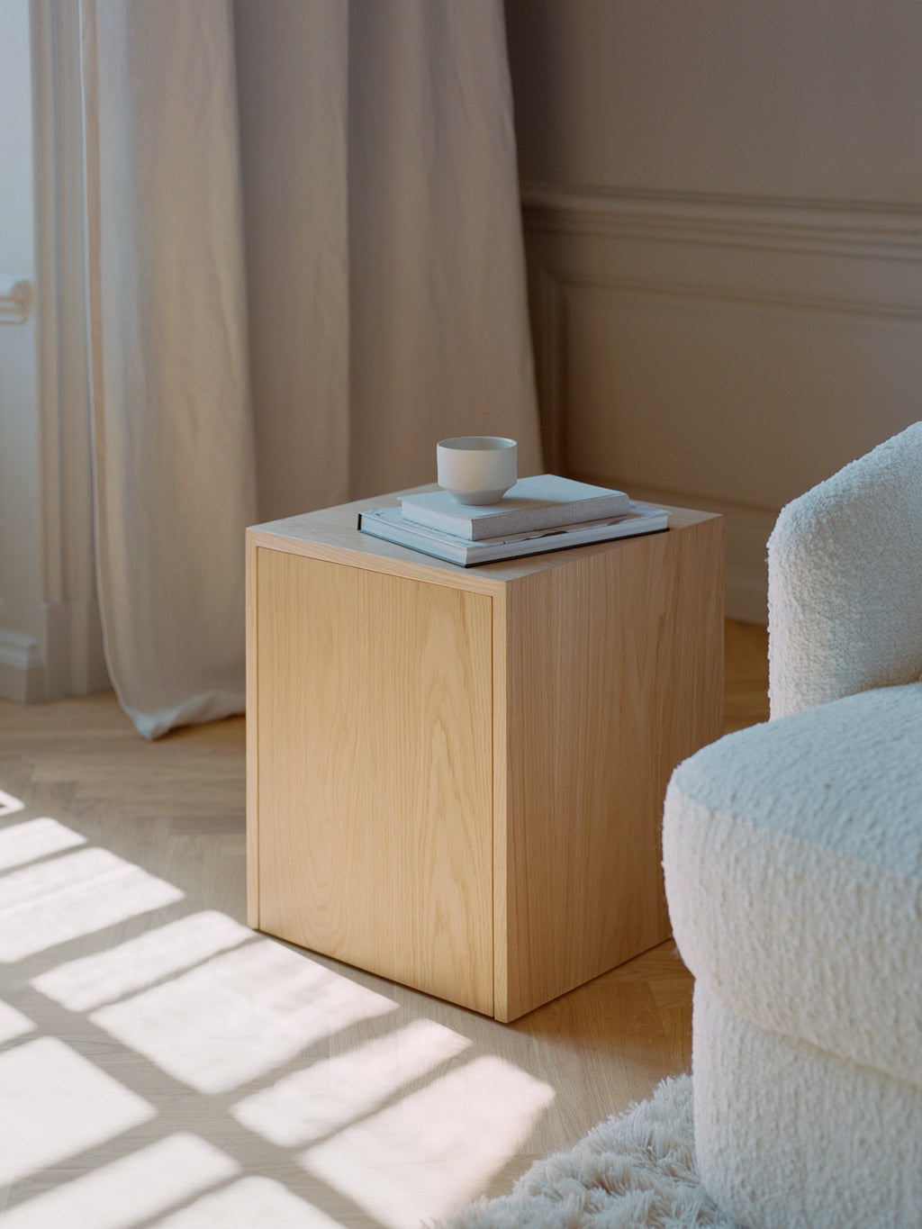 New Works Mass Side Table w. Drawer, a modern minimalist cube side table crafted from light natural oak veneer with a smooth wood grain finish and clean, precise lines, featuring a discreet integrated drawer for hidden storage. This versatile blonde wood accent table is perfect as a Scandinavian bedside table or contemporary living room end table for design-conscious interiors.