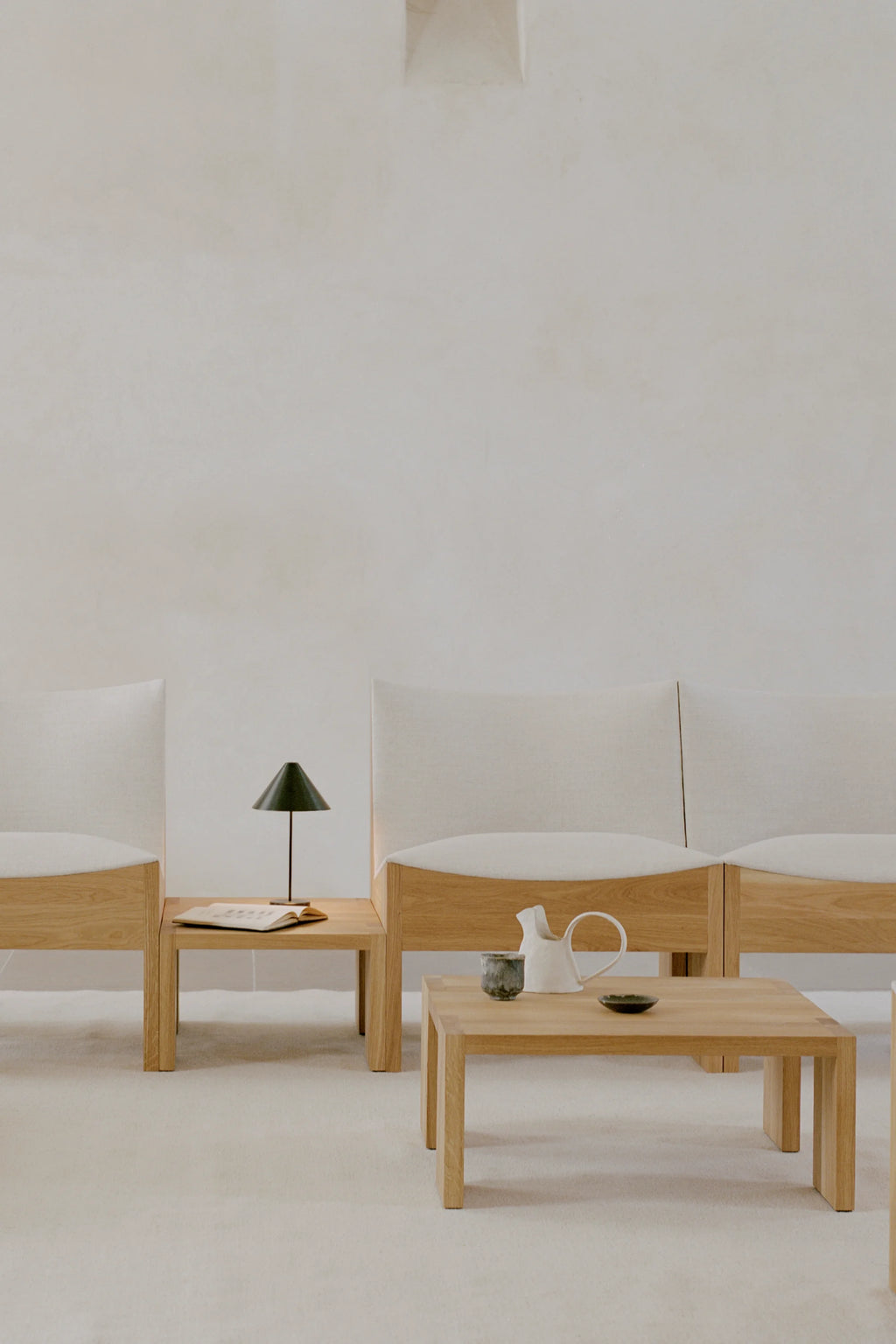 New Works Tenon Side Table, a modern minimalist coffee table crafted from natural solid oak with a smooth, light wood grain finish and clean rectangular silhouette. Its robust, block-like form and simple lines define a contemporary Scandinavian aesthetic, offering both functionality and understated design. Perfect as a low-profile side table or coffee table for minimalist living rooms or serene lounge areas.
