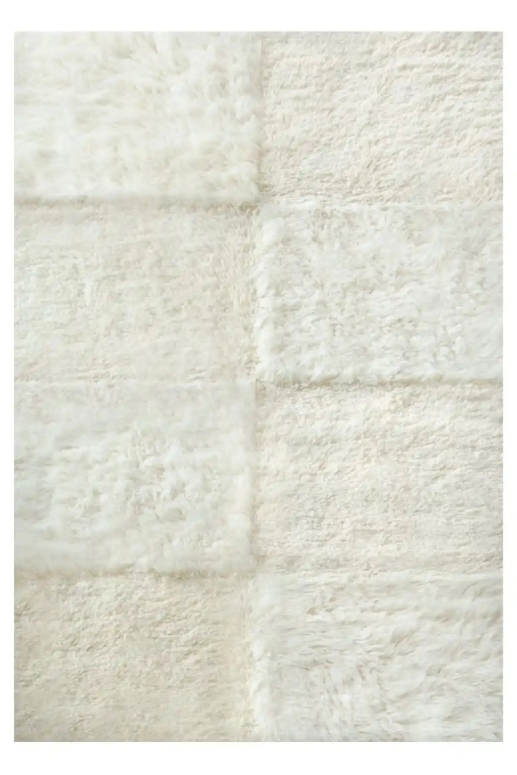 Layered Shaggy Checked Rug, a soft off-white fluffy area rug with a subtle checkerboard pattern from varying pile directions. Perfect for adding cozy texture to modern living spaces.