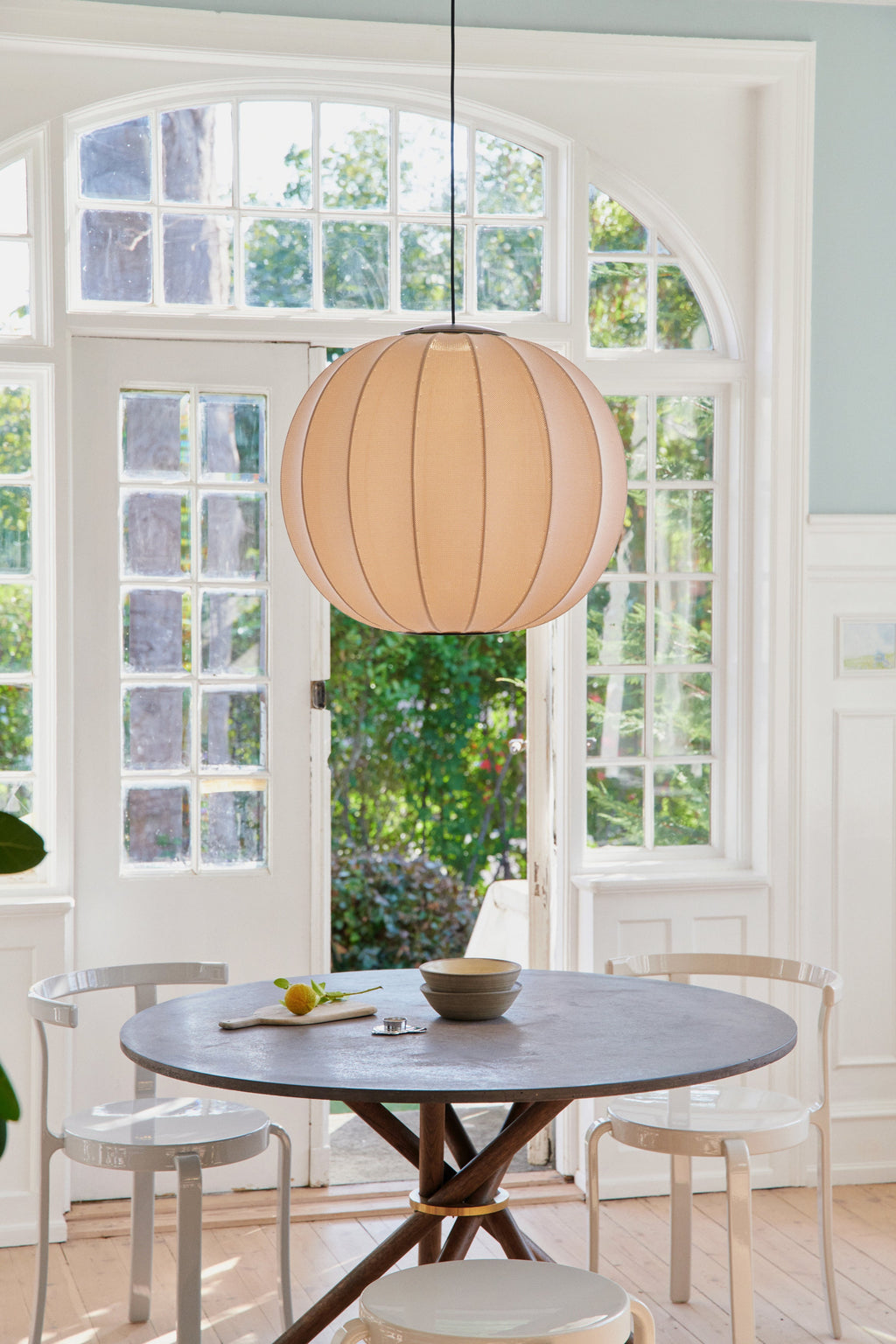 Made by Hand Knit-Wit Ø60 Round Pendant Lamp, a modern Scandinavian spherical pendant light crafted from a unique light beige woven textile with a ribbed, globe-like form that diffuses light softly. This contemporary knit fabric ceiling lamp creates a warm, inviting glow. It is perfect for minimalist dining rooms, cozy living spaces, or organic modern interiors.