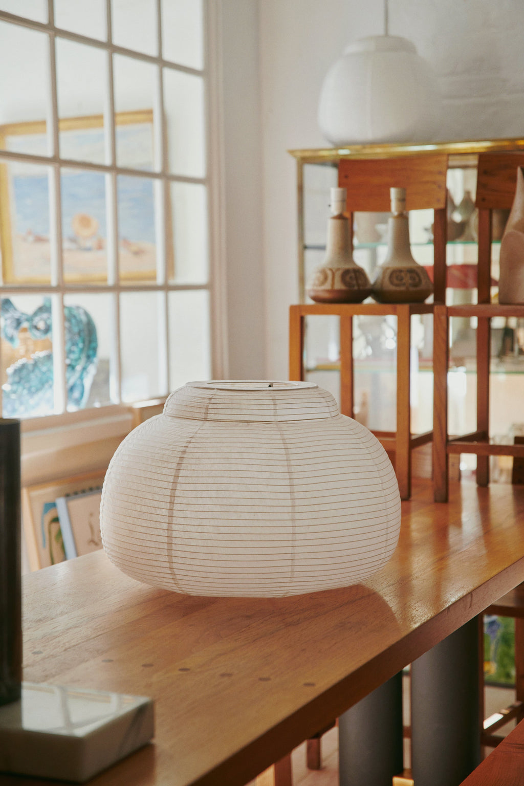 Made by Hand Papier Single Ø52 Pendant Lamp, an elegant japandi-style ceiling light crafted from natural off-white paper with fine horizontal lines and a distinct rounded, flattened lantern silhouette.