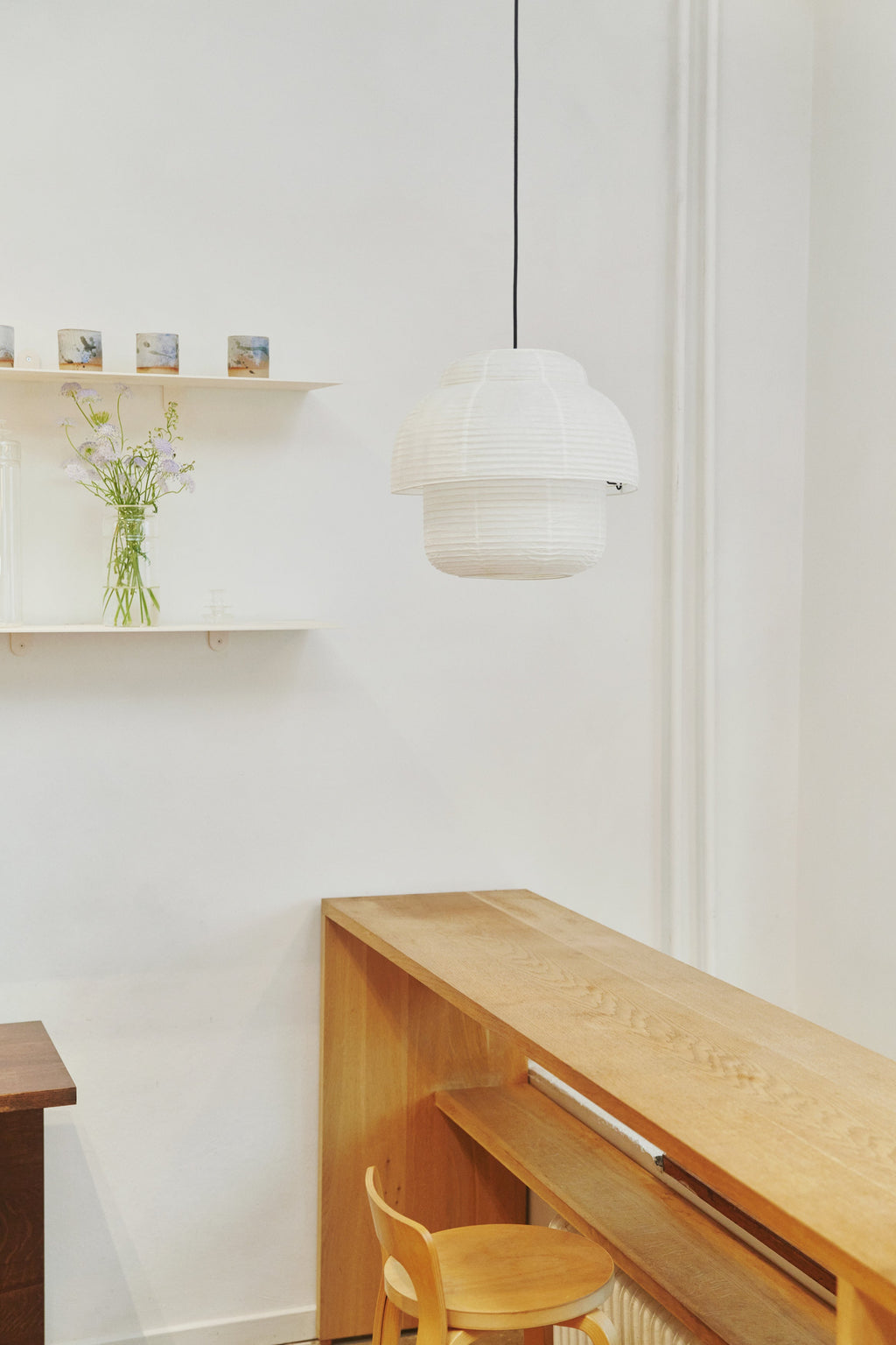 Made by Hand Papier Double Ø40 Pendant Lamp, a contemporary Scandinavian pendant lamp crafted from delicate white ribbed paper with a unique double-tiered, organic silhouette. Its soft, translucent paper shade emits a warm, diffused light, perfect for creating a serene atmosphere. Ideal for Japandi living rooms, minimalist dining areas, or cozy organic modern bedrooms.