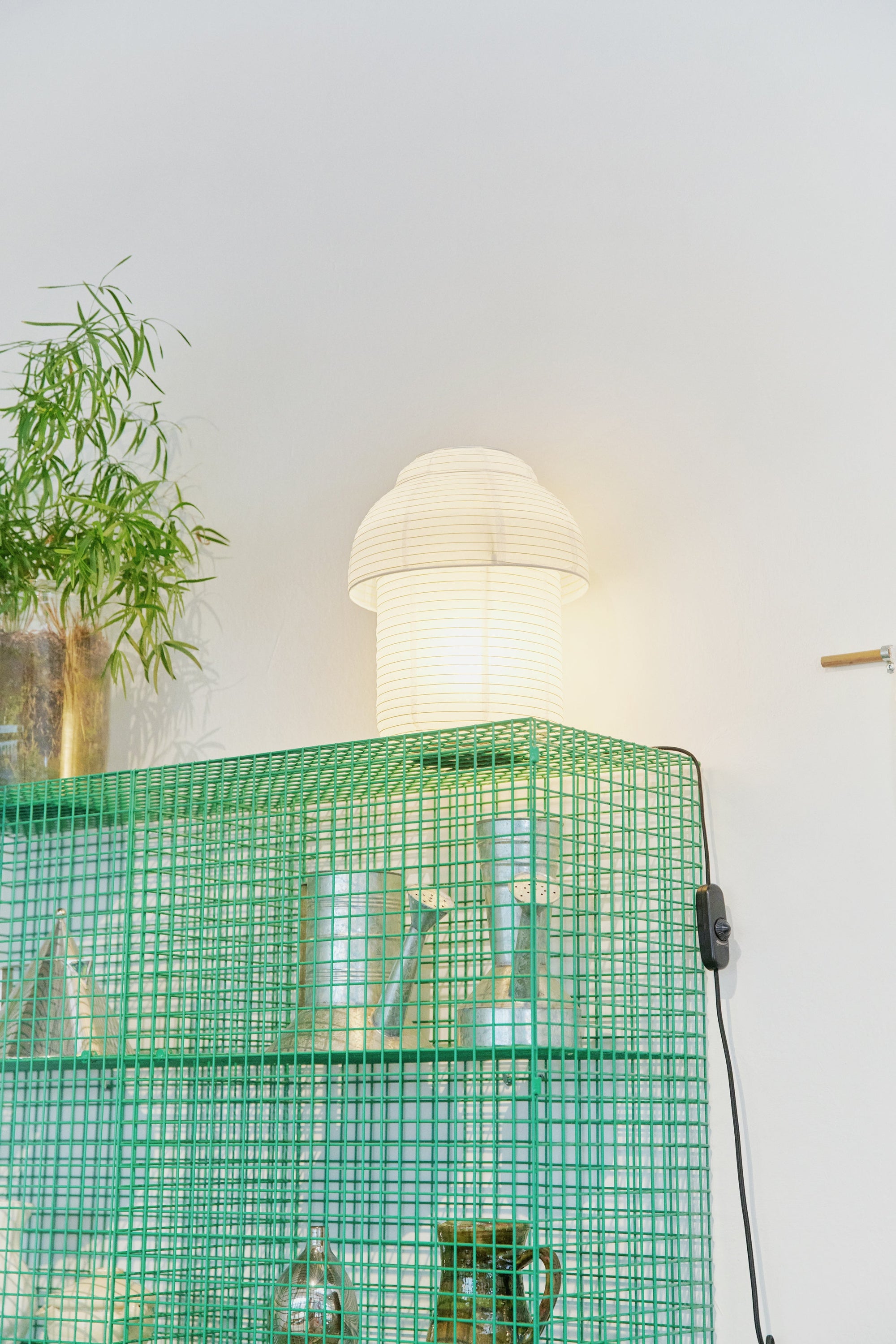 Made by Hand Papier Double Ø30 Table Lamp, a cream-colored minimalist table lamp crafted from delicate, ribbed Japanese Washi paper with a distinctive double-tiered, mushroom-like silhouette, emitting a soft, ambient glow. This Scandinavian-inspired organic modern lamp is perfect for creating a serene atmosphere in Japandi living rooms, bedrooms, or for elegant shelf styling.