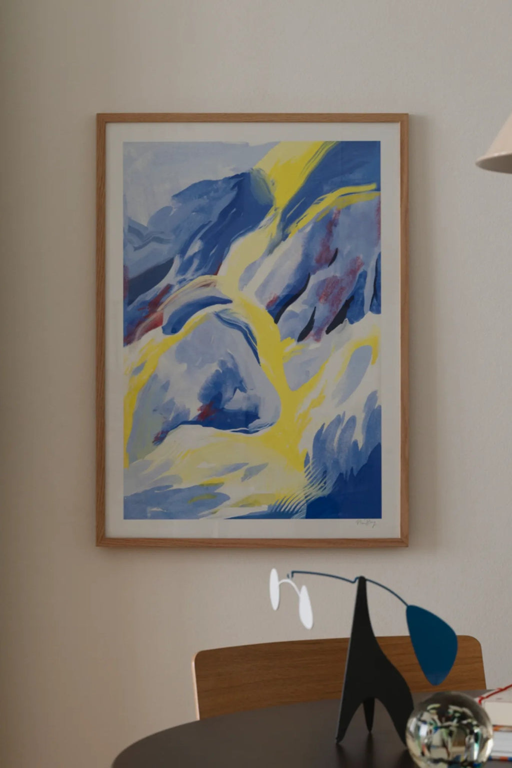 The Poster Club Blue Strokes, an abstract art print featuring dynamic blue and yellow brushstrokes with subtle red accents, creating a sense of movement and depth. This contemporary poster is framed in a light natural oak frame with a crisp white mat. Perfect for adding a vibrant focal point to modern living rooms, minimalist bedrooms, or a stylish gallery wall.