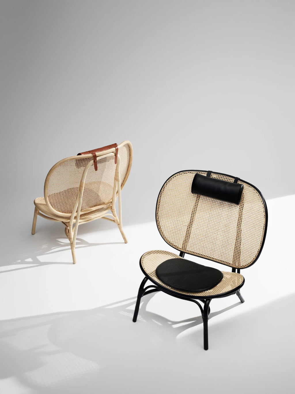 NORR11 Nomad Chair, featuring a premium woven cane seat and back with elegant leather accents. This stylish lounge chair offers durable, modern comfort for refined living spaces.