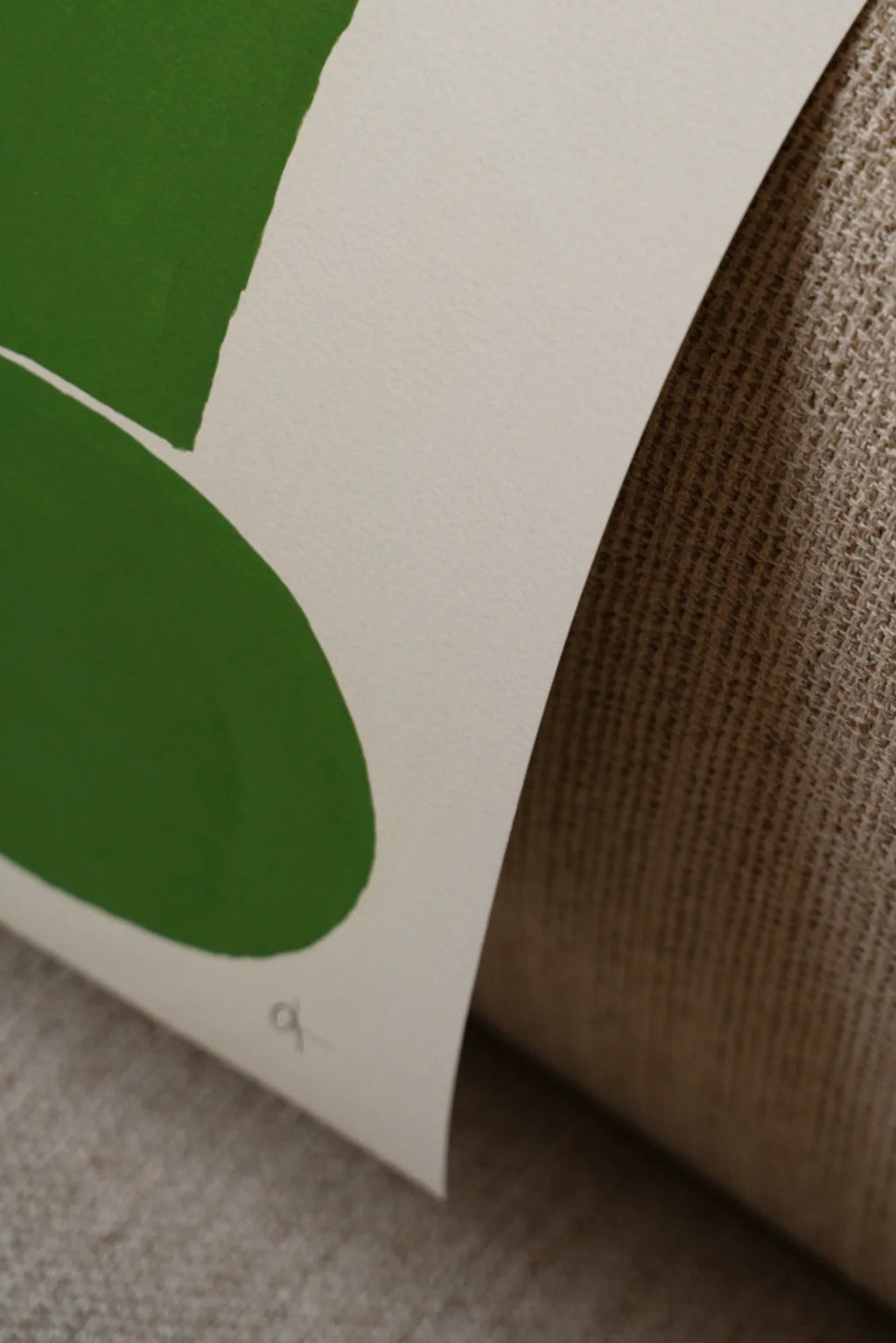 The Poster Club 9 pm, a minimalist abstract art print featuring bold organic green shapes on a textured off-white art paper background, showcasing its rich pigment and quality.