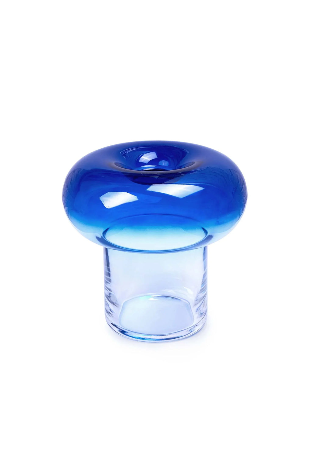 TAMO Orio Vase with a clear cylindrical base and a vibrant royal blue, concave, donut-shaped top, crafted from premium art glass, flat lay on white. Impressive modern decor.