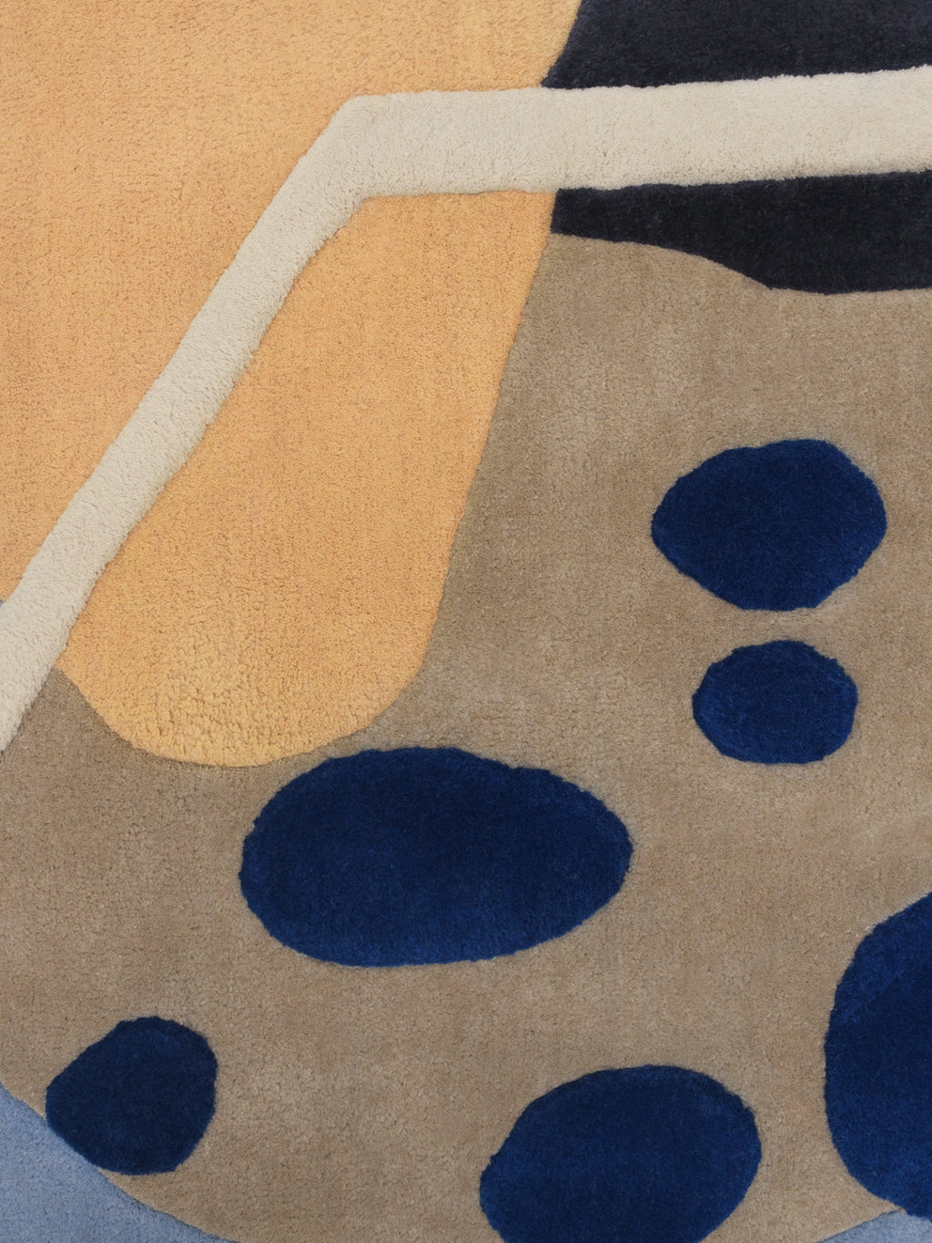 Haus Üger Papillon Rug, a hand-tufted wool rug featuring a bold abstract design with organic shapes and varied pile heights, showcasing a vibrant color palette of deep orange, beige, navy blue, cream, and light blue accents. This contemporary textured area rug is perfect for adding artistic flair to modern living rooms, creative bedrooms, or playful kids' spaces.