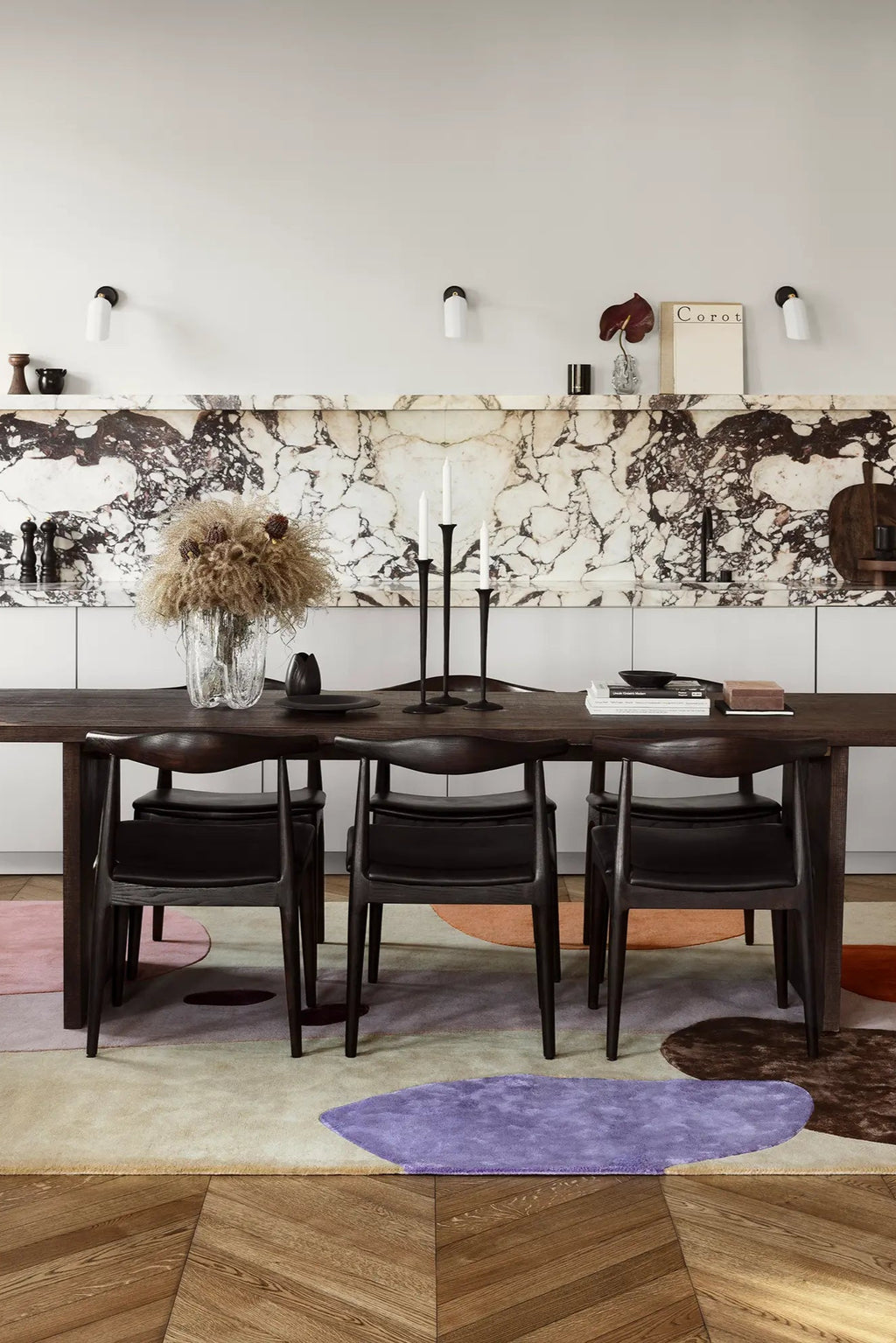 Layered Magical Garden Wool Rug, a modern abstract area rug featuring organic shapes in purple, pink, and brown tones on a neutral background. Perfect for adding a soft, artistic touch to contempor...