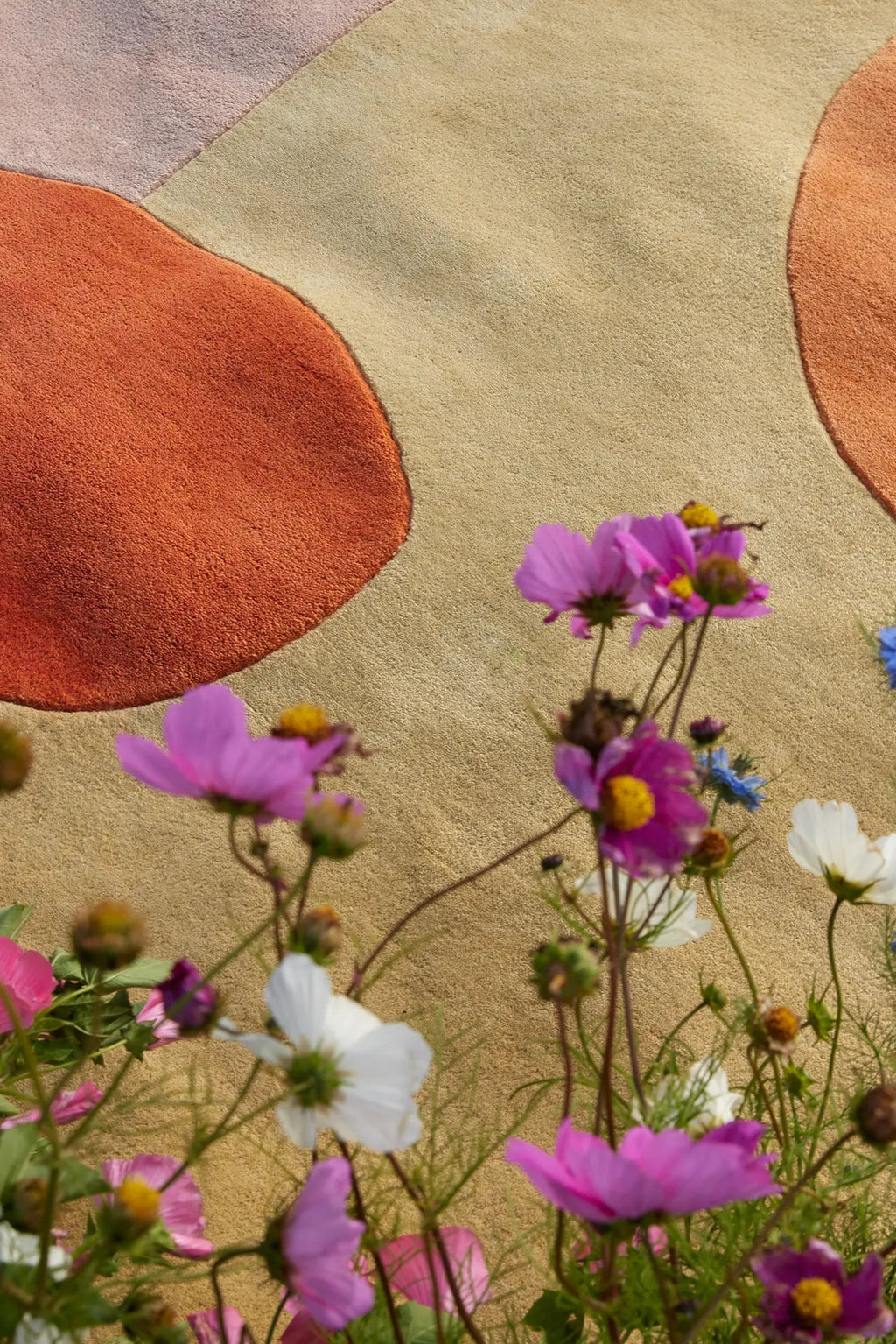 Layered Magical Garden Wool Rug, a plush, textured area rug featuring organic shapes in warm terracotta, beige, and light green, with a soft pile finish. Perfect for adding a natural, artistic touc...
