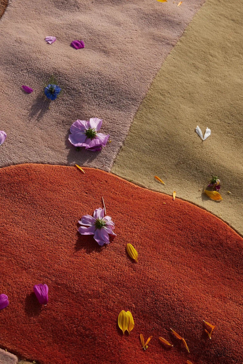 Layered Magical Garden Wool Rug, a multicolored abstract area rug with warm earthy tones of rust, beige, and brown, featuring a plush, soft texture. Perfect for adding a cozy, artistic touch to any...