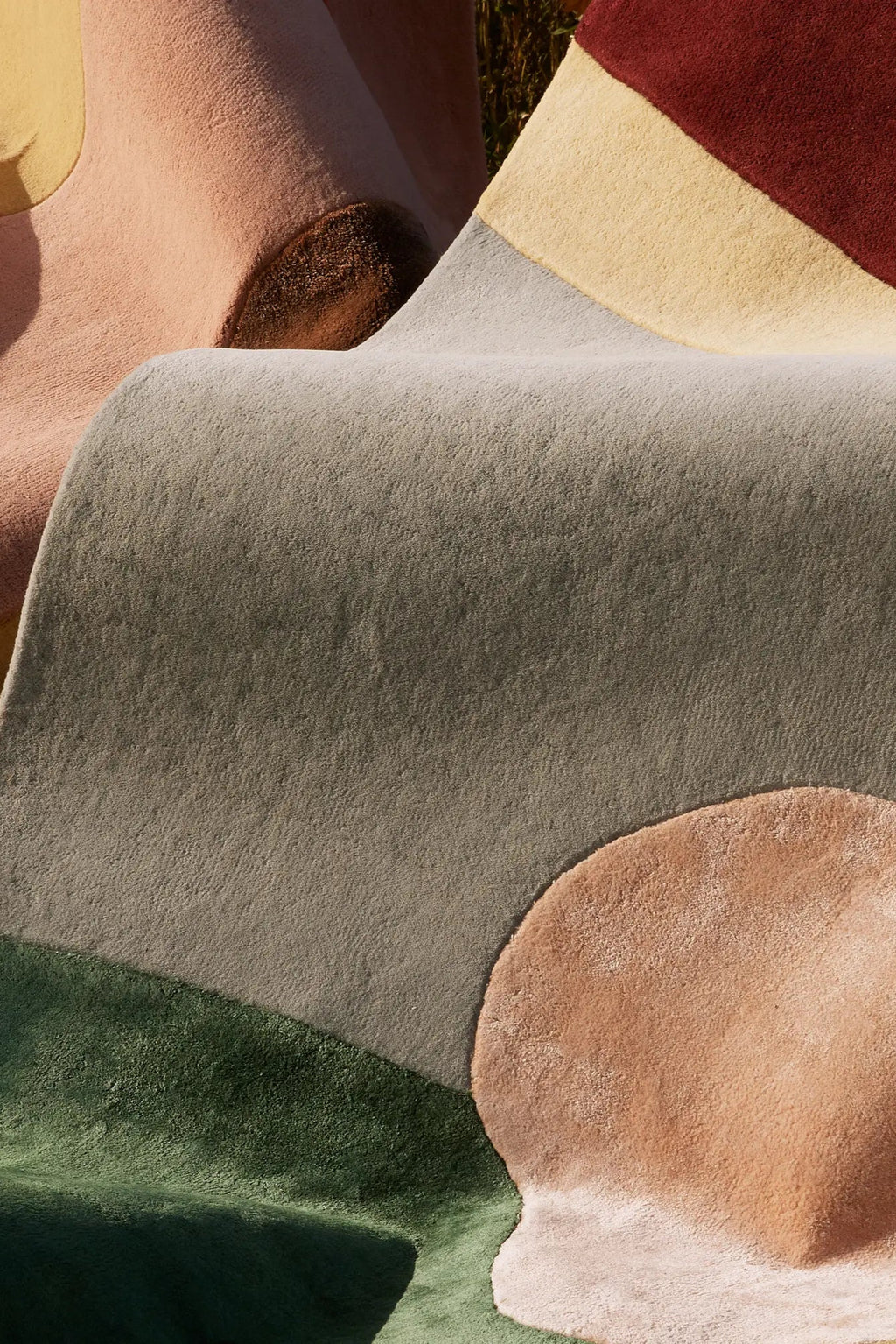 Layered Sleeping Flower Wool Rug, a plush, multi-textured area rug featuring abstract organic shapes in muted tones of sage green, blush pink, and earthy brown. Perfect for adding a soft, artistic...