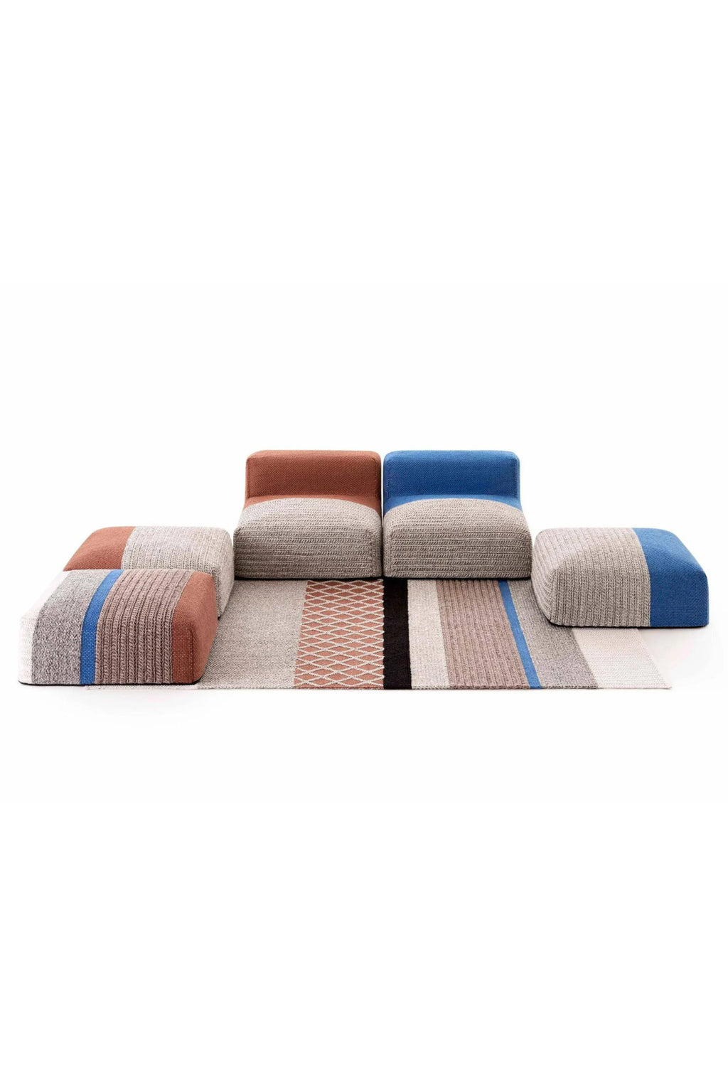 GAN Rugs Mangas Outdoor Composition 2, a contemporary modular outdoor sofa system featuring low-profile seating units and an integrated flatweave rug, all crafted from durable woven outdoor fabric.