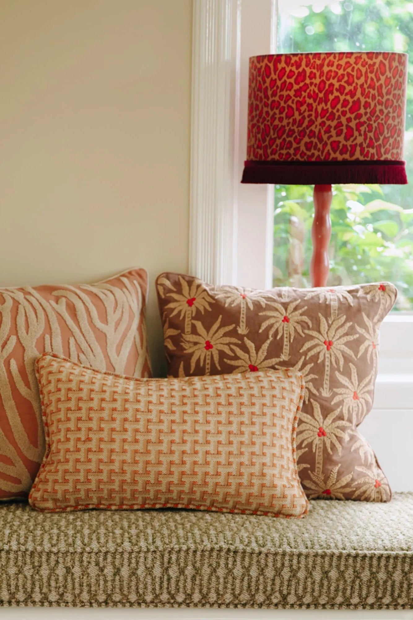  A close-up of a Laura Cushion in a soft, textured fabric with tassels