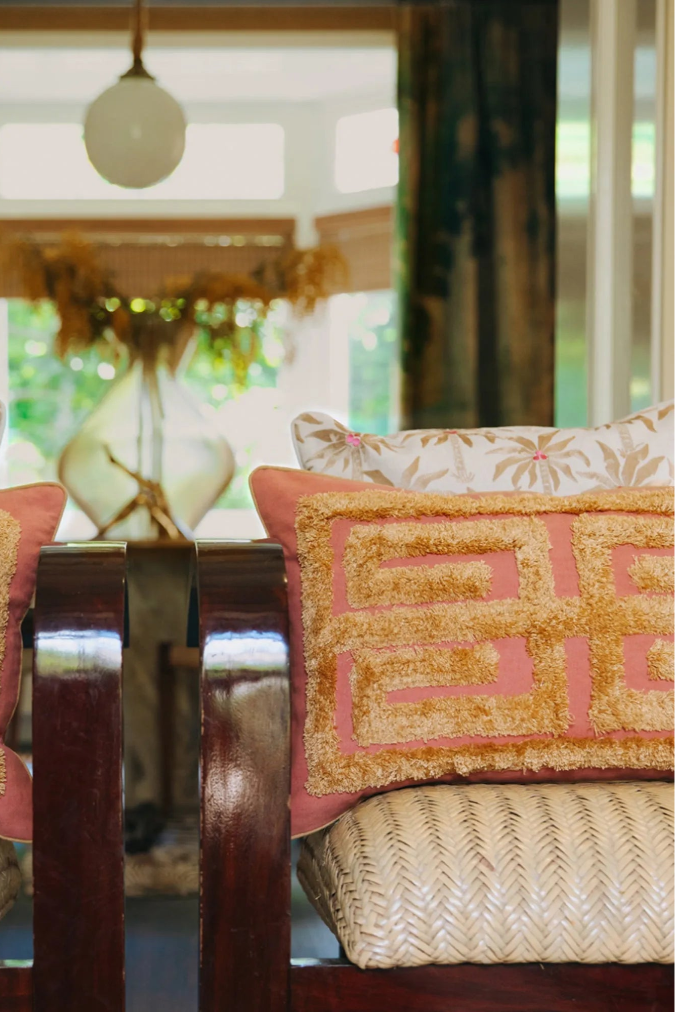  A close-up of a luxurious velvet Laura Cushion in a deep emerald green