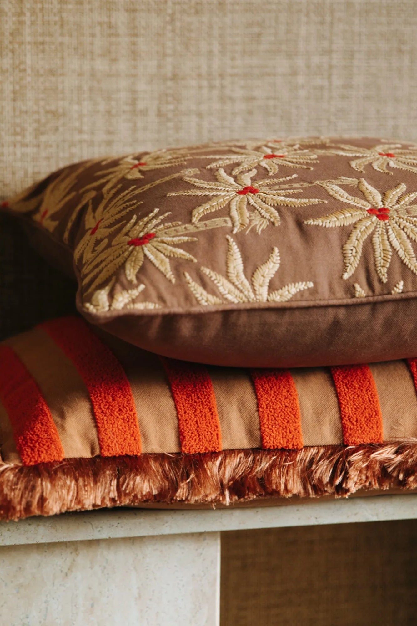  A cozy reading nook featuring a Laura Cushion in a warm, inviting space