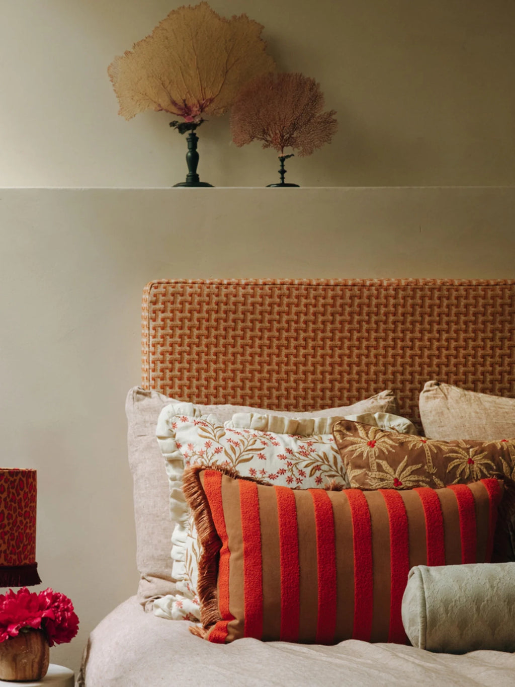 Palais Jackie Throw Pillow, a rectangular lumbar cushion featuring a rich brown base with bold, plush red vertical stripes and coordinating fringed edges. This textured cotton throw pillow adds a vibrant, eclectic pop of color and cozy boho style.