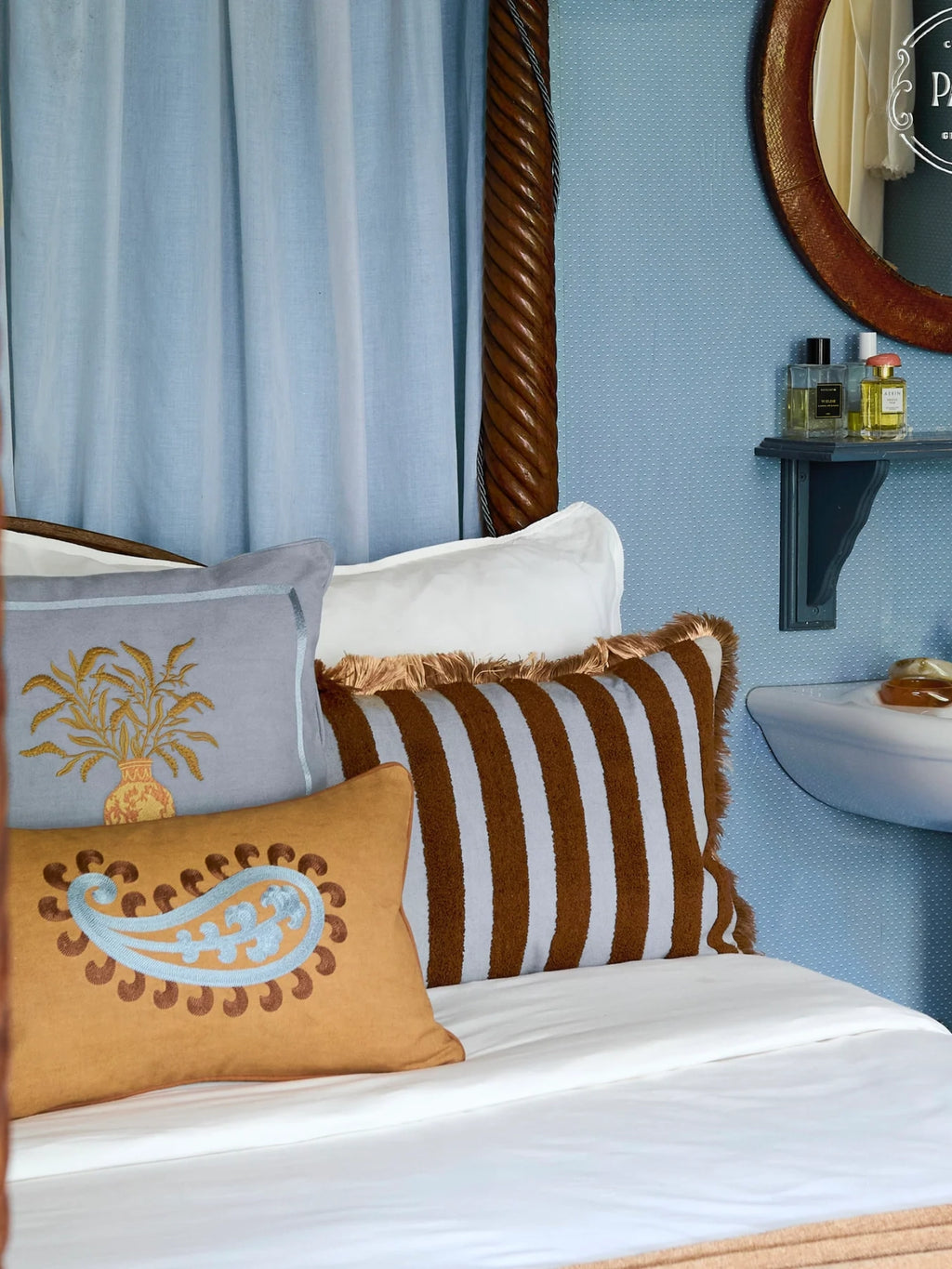 Palais Double Sided Siena Throw Pillow, a rectangular camel-colored cushion crafted from soft fabric, featuring intricate light blue paisley embroidery accented with subtle brown dots for a rich, textured look.