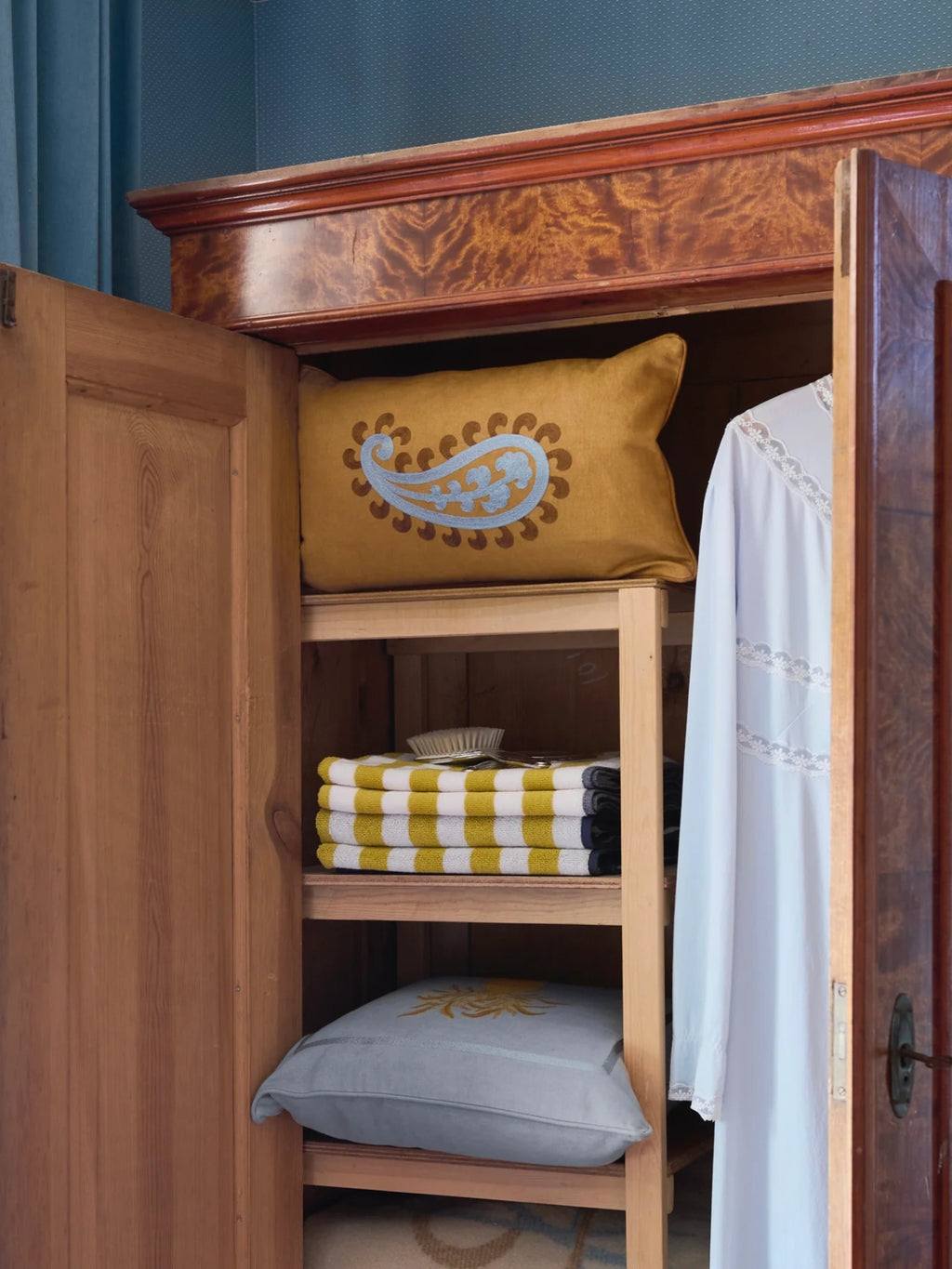 Palais Double Sided Siena Throw Pillow, a rectangular decorative cushion featuring a vibrant mustard yellow soft fabric with a classic blue paisley embroidery design.