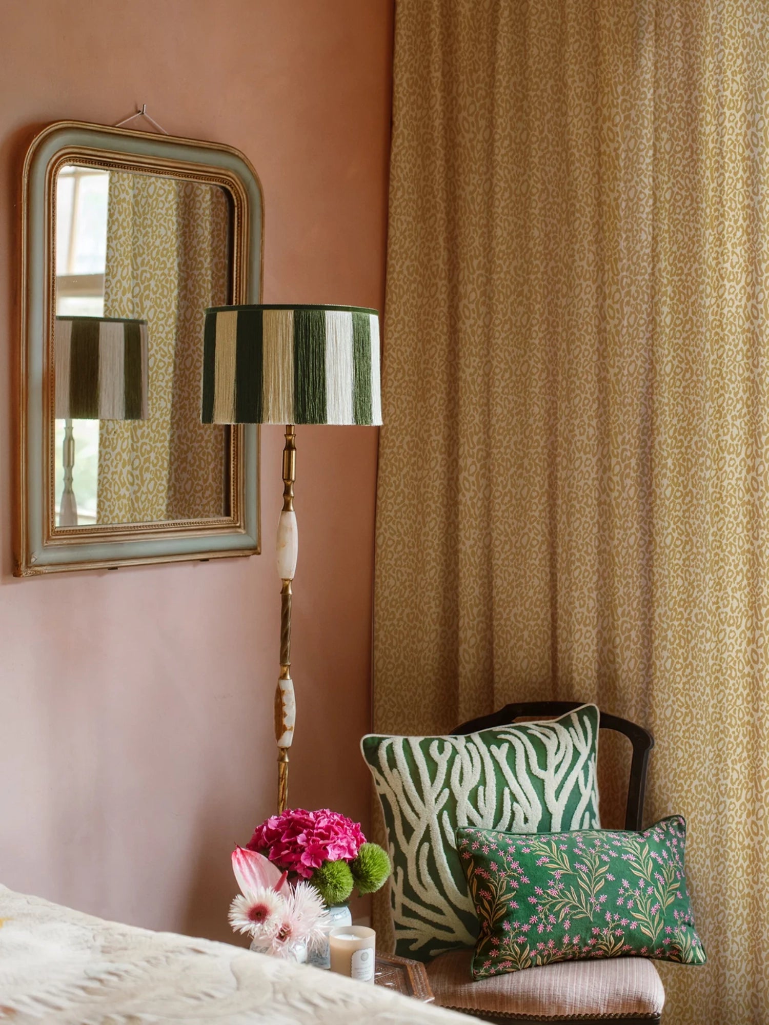 Palais Lauren Throw Pillow, a luxurious rectangular deep forest green velvet cushion adorned with intricate pink floral embroidery and delicate gold botanical details. This elegant embroidered accent pillow, perfect for maximalist or romantic interiors, adds a vibrant touch to eclectic living rooms or cozy bedrooms.