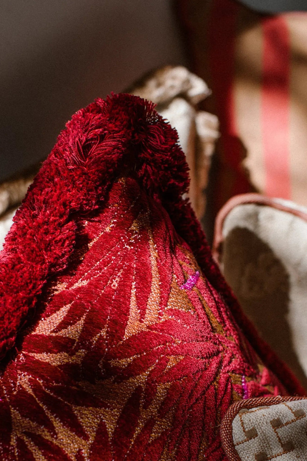 Yoko Bolster Pillow in magenta, adds a touch of luxury to your seating area