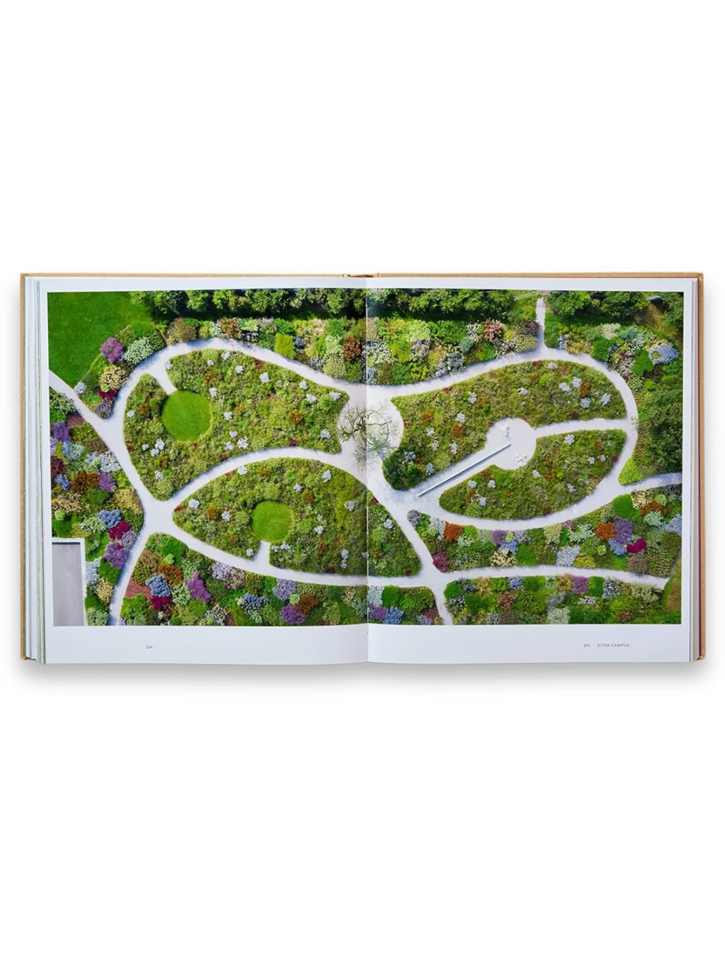 Book Piet Oudolf at Work, an open book displaying a vibrant aerial view of a meticulously designed garden with winding white paths and richly textured plantings in shades of green, purple, and blue. This essential gardening book offers inspiration for landscape architects and home garden enthusiasts.