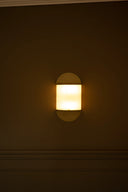 Wall-mounted light fixture on a dark wall