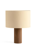 Table lamp with beige shade and wooden base on a white background