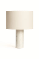 Table lamp with a beige shade and marble base on a white background